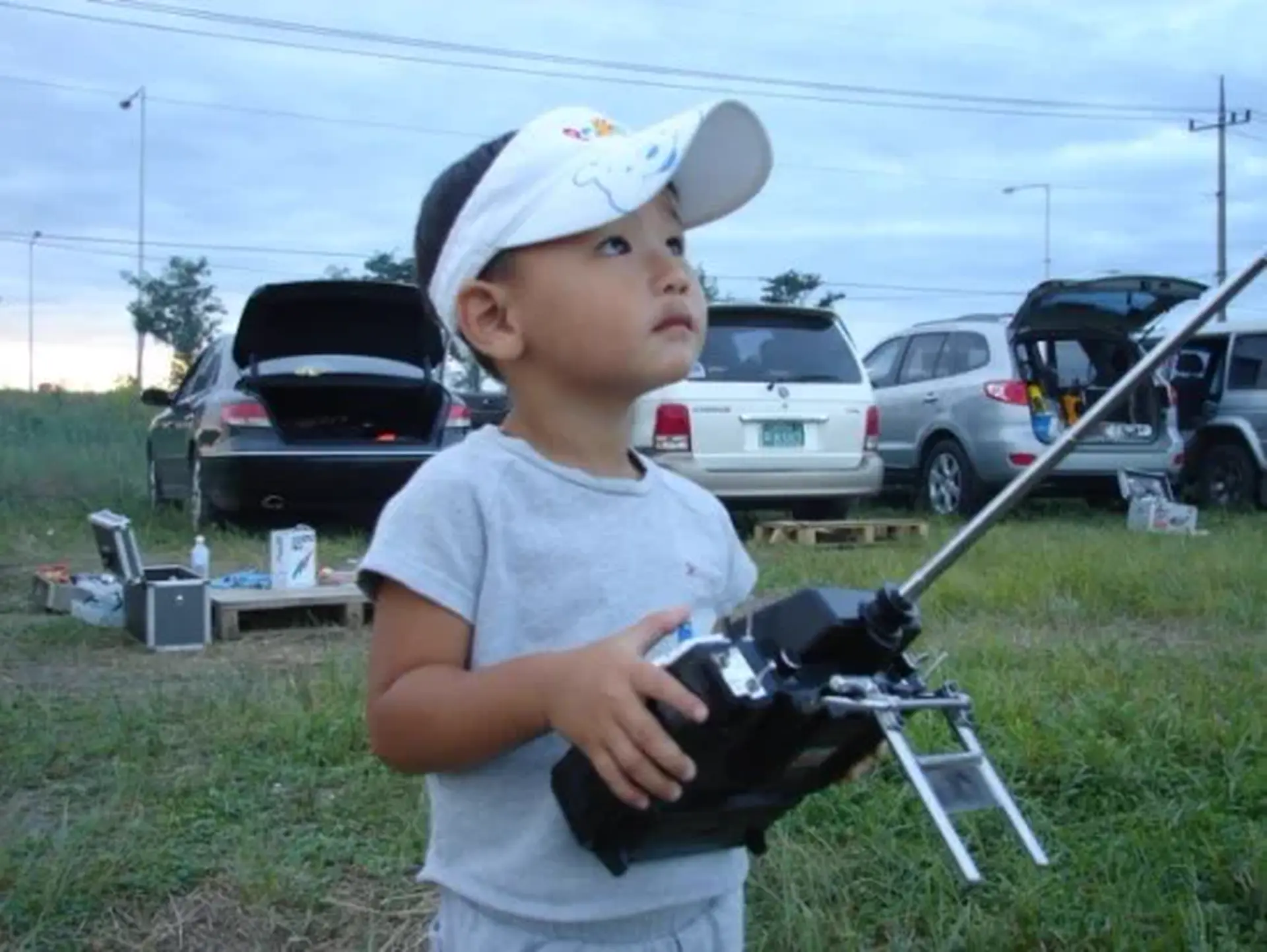 MinChan Kim at age three, holding an RC helicopter transmitter for the first time